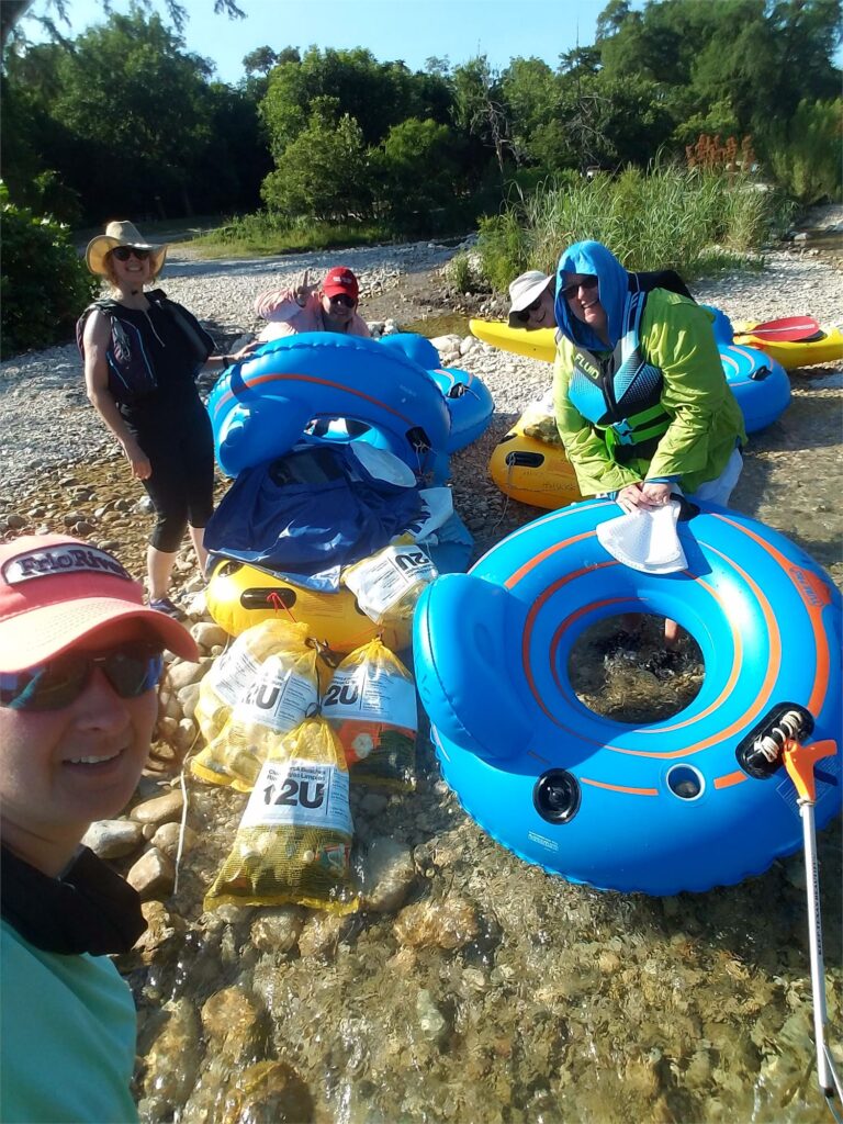 people tubing and picking up trash from the river