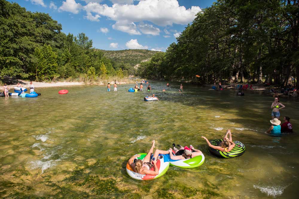 groups of people floating on a river