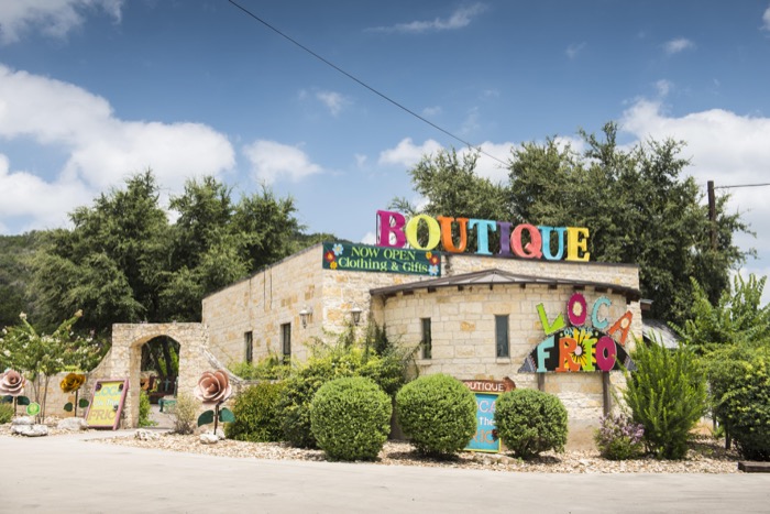Colorful boutique with a vibrant sign and charming garden setting in Uvalde County, Texas in Uvalde County, Texas