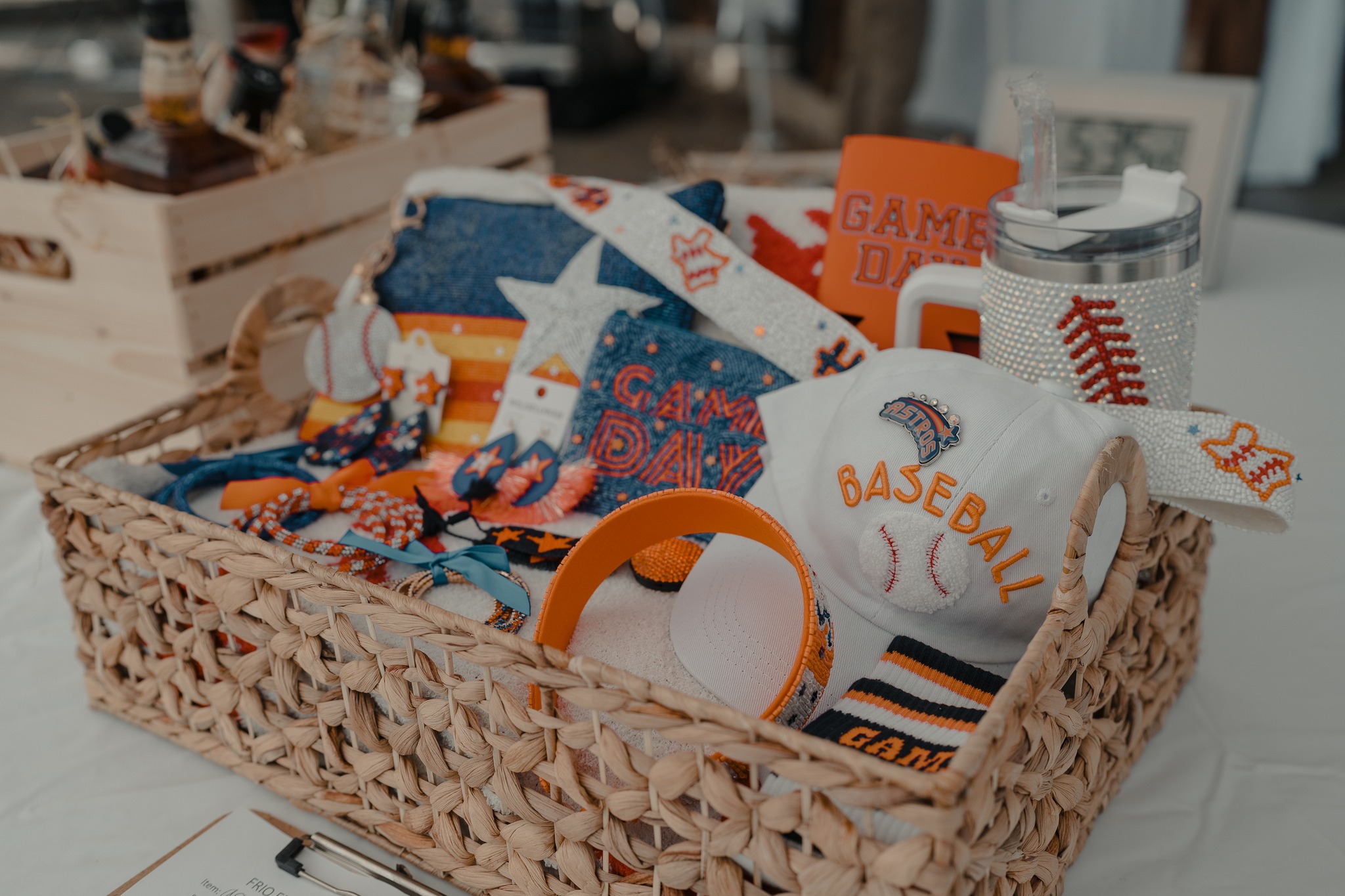 A woven basket filled with colorful baseball-themed items, including a hat, scarf, and various accessories in Uvalde County, Texas