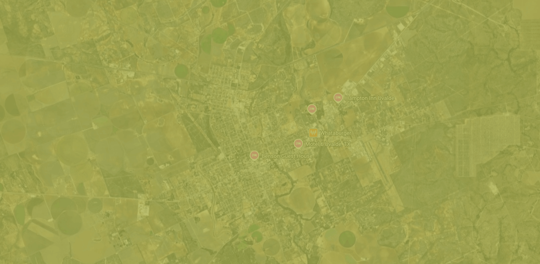 A serene poolside retreat at Concan Vacation Homes, featuring a sparkling pool, comfortable lounge chairs, and a cozy outdoor living area in Uvalde County, Texas