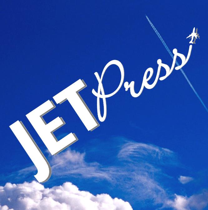 A blue sky with clouds and an airplane flying overhead, with the text 'JET PRESS' in white in Uvalde County, Texas