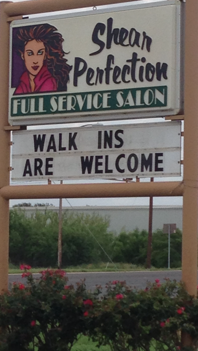 A sign for Shear Perfection Full Service Salon with a welcoming message for walk-ins in Uvalde County, Texas