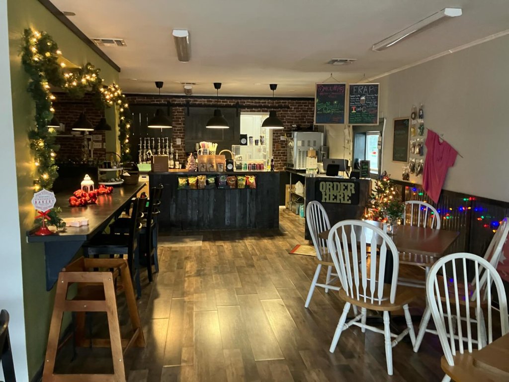 Cozy cafe interior with wooden floors, festive decorations, and a welcoming atmosphere in Uvalde County, Texas