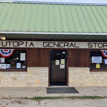 A small general store with a green metal roof and a wooden sign reading 'Utopia General Store' above the entrance in Uvalde County, Texas