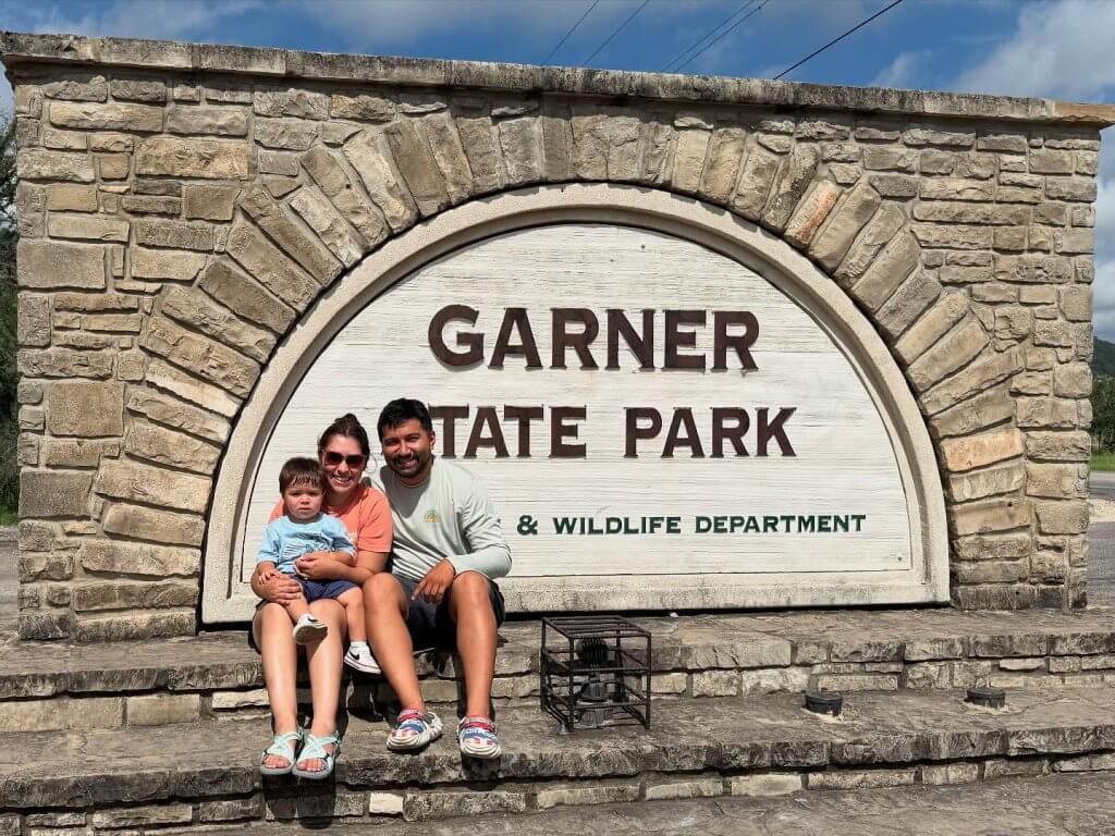 A Family posing at the Garner State Park sign